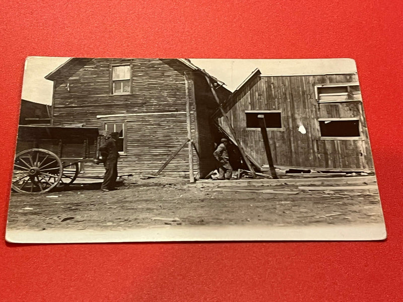 Building tipped on its side. 1918 Tornage RPPC